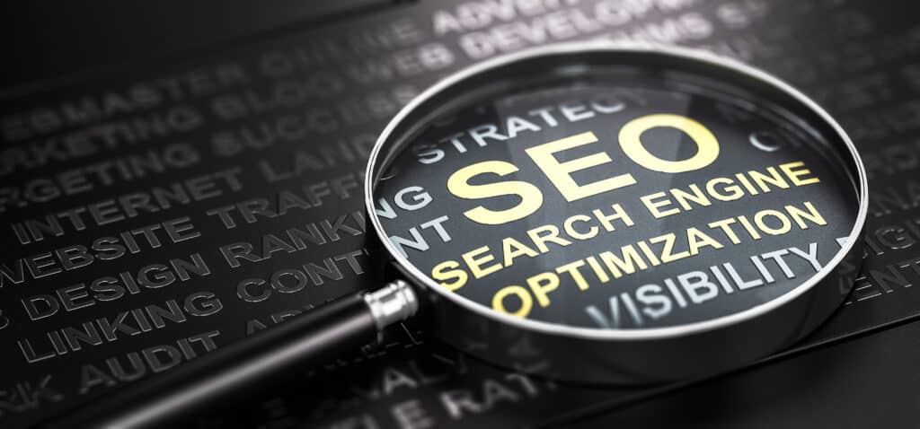 A magnifying glass highlights the words SEO Search Engine Optimization.