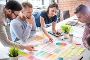 A Team looks over their marketing strategy while sitting at a table.