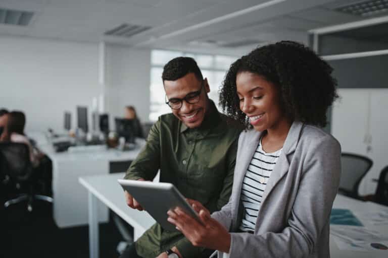 Two business people looking at a tablet.