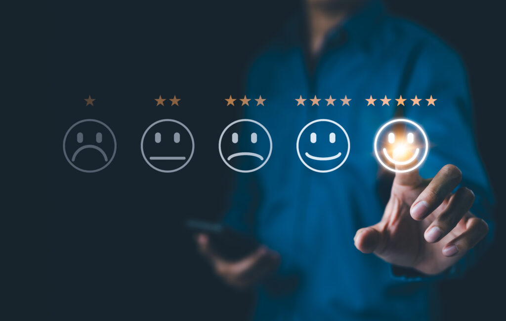 Customer review satisfaction feedback, touching a smiley face, 5 stars.